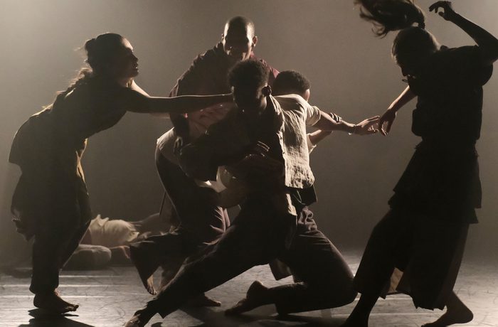 Dancers on stage in dim lighting