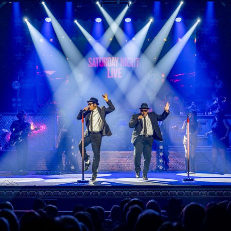 A Blues Brothers tribute performing a song live on stage.