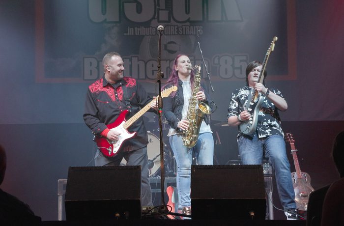 A group of musicians performing on a stage