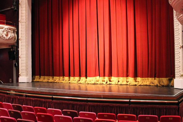 Theatre Royal Winchester's stage with the red and yellow curtain down