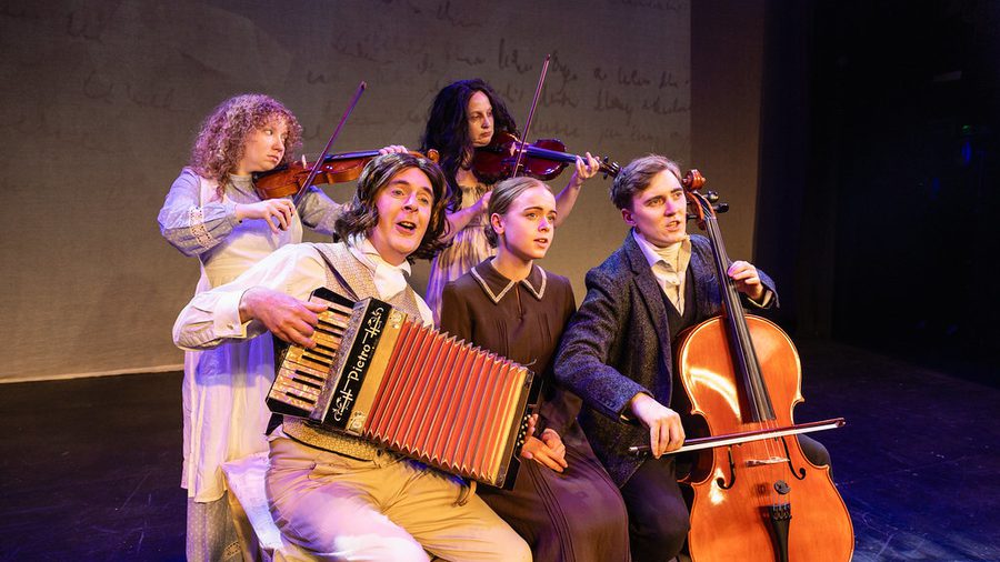 A group of people in period costume, playing musical instruments.