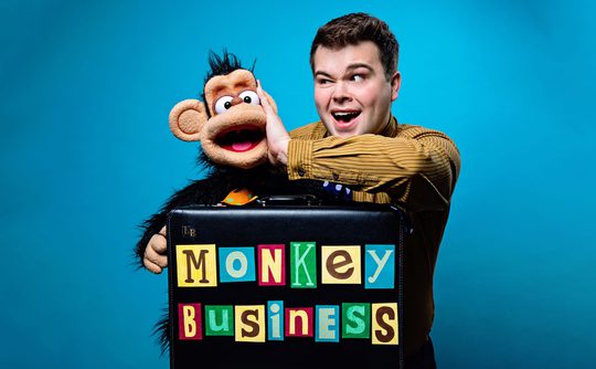 Max Fulham holding a puppet of a monkey.