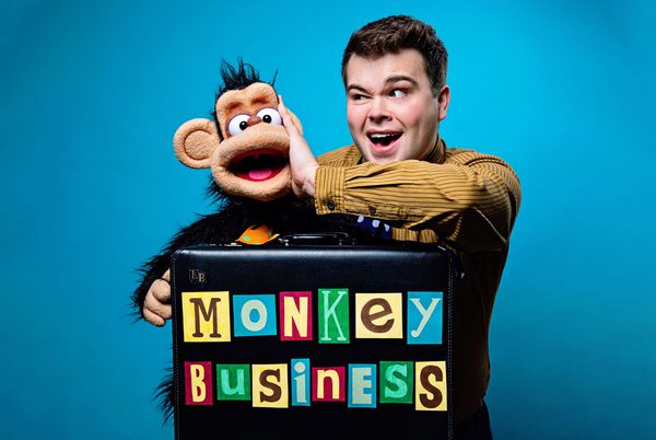 Max Fulham holding a puppet of a monkey.