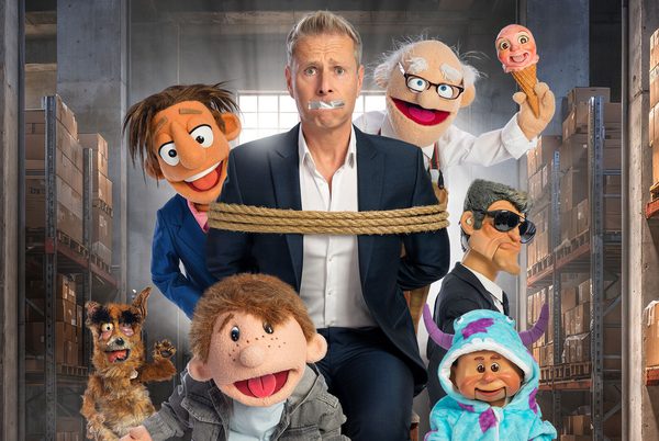 Paul Zerdin bound and gagged, and surrounded by puppets.