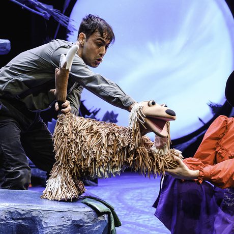 Performers with a puppet dog