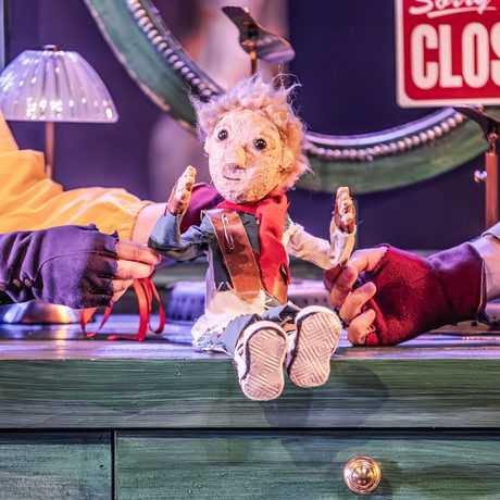 A puppet elf sat on a table.