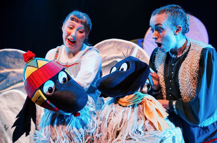 Two performers operating yak puppets
