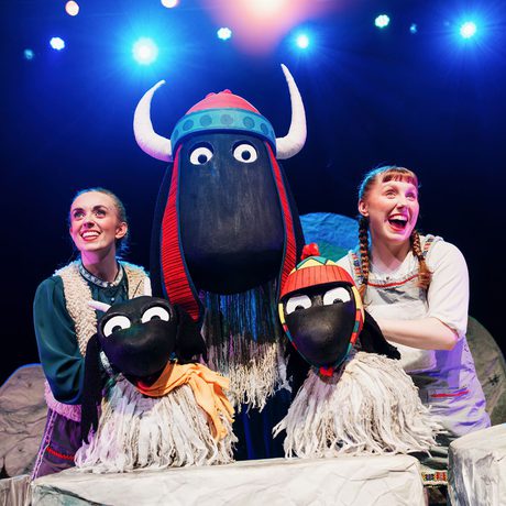 Two performers operating yak puppets
