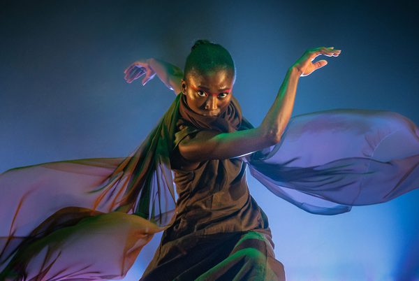 A contemporary dancer in a flowing scarf