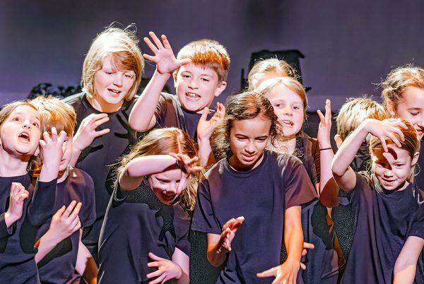 A group of young people performing with dramatic poses