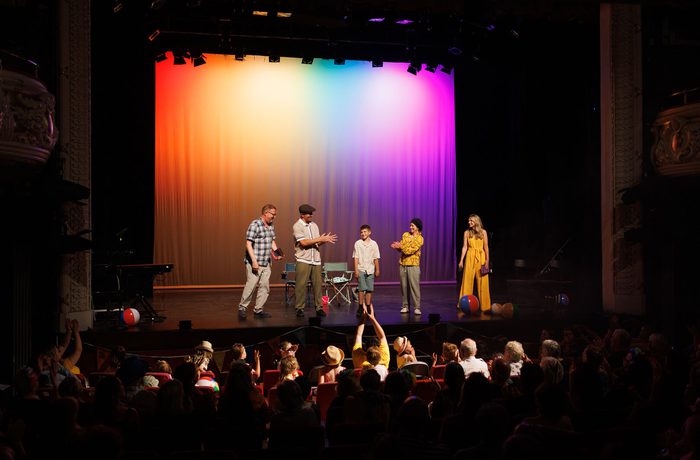 A group of people on stage, in front of a large audience