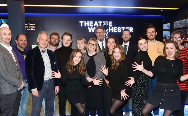A large group of people posing with jazz hands at Theatre Royal Winchester