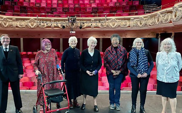 A group of care home residents on the stage at Theatre Royal Winchester