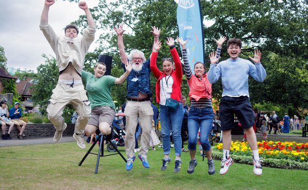 A group of people jumping up in the air in celebration