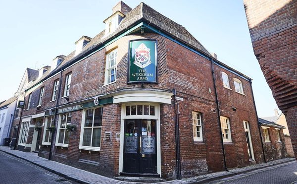 The Wickham Arms pub in Winchester. A redbrick building on the corner of the street