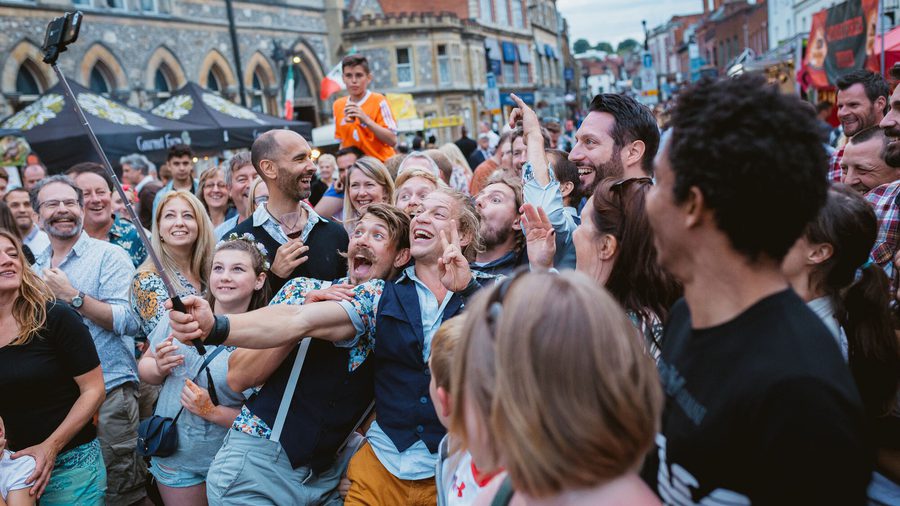 A large crowd of people posing for a photo on the streets of Winchester