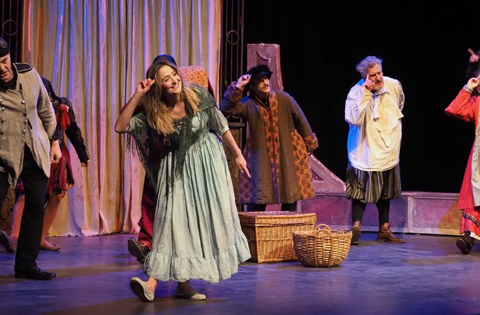 Performers dancing on stage and looking happy