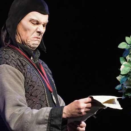 A performer looking repulsed as their read a piece of paper