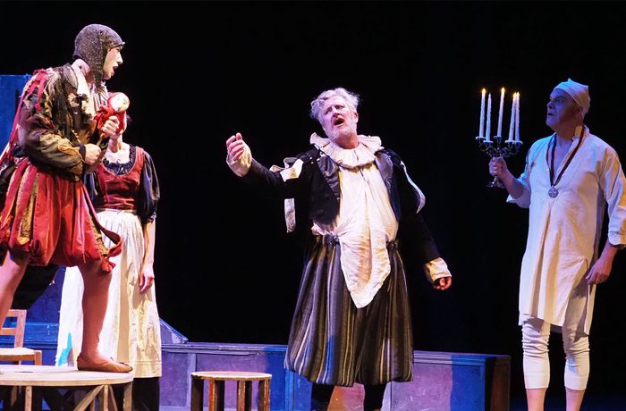 Performers on stage looking dramatic