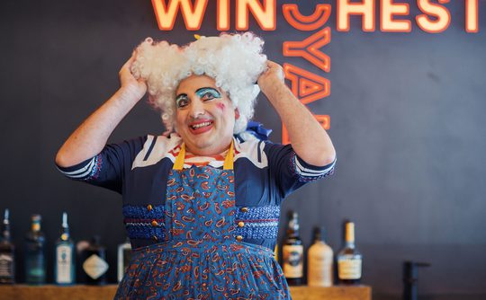 A panto dame at the theatre bar.