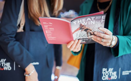 A person opening a theatre what's on brochure.
