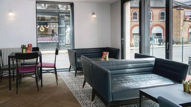 Sofas, chairs and a table in Theatre Royal Winchester's foyer.