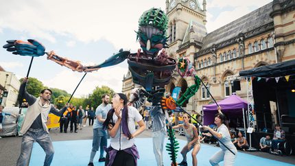 A giant puppet in the street outside of Winchester Guildhall.