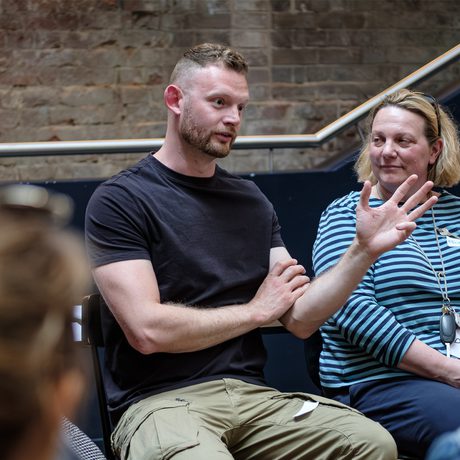 A group of people sat in discussion.