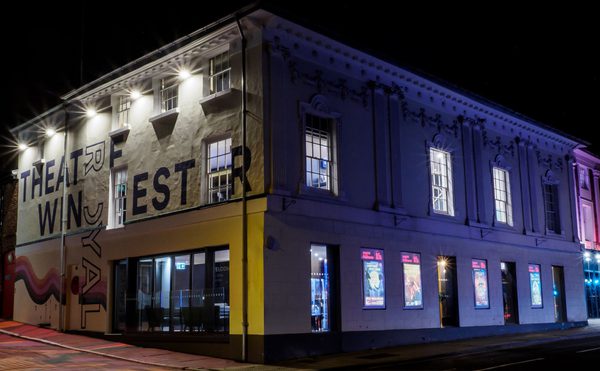 Theatre Royal Winchester lit up at night.