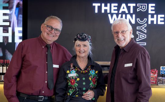 Three volunteer ushers stood in front of the bar in Theatre Royal Winchester's foyer.