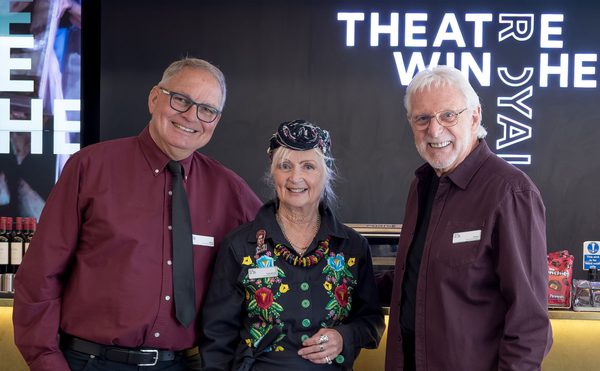 Three volunteer ushers stood in front of the bar in Theatre Royal Winchester's foyer.