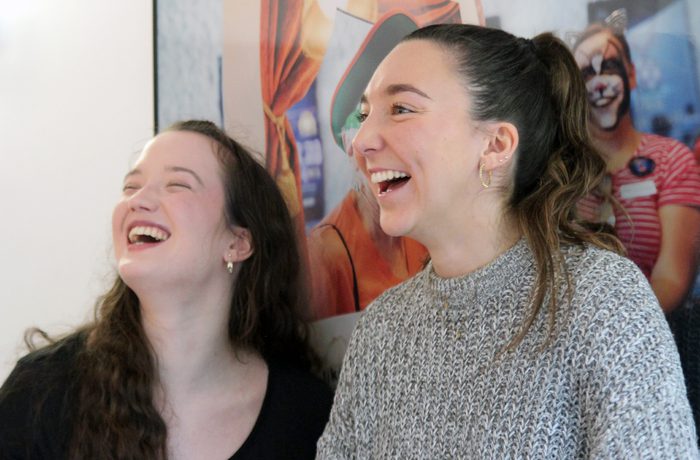 Two young adults laughing.