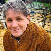 Dan Angus, Business and Operations Director, brown zip-up fleece.
