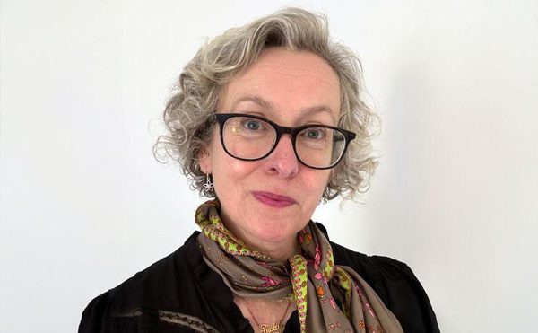 Dr Helen Grime, Board Member, dark top, brown scarf, glasses