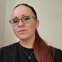 Marisa Goldsborough, Fundraising Manager, black top, necklace, glasses