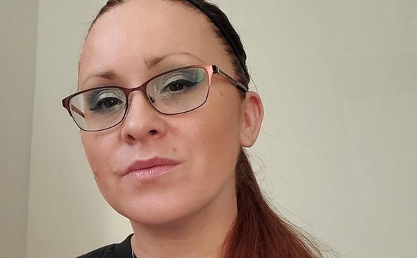 Marisa Goldsborough, Fundraising Manager, black top, necklace, glasses
