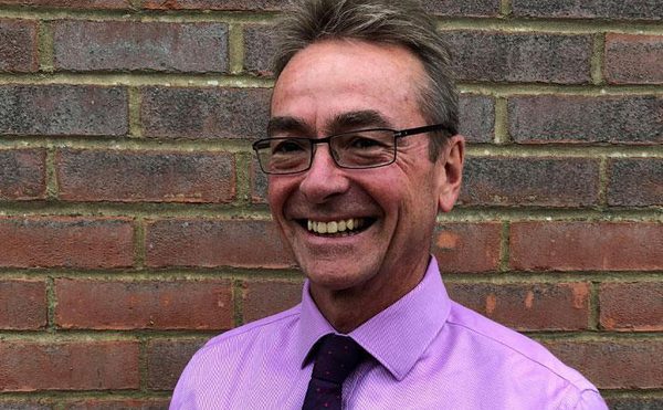 Steven Cross, Board Member, purple shirt, black tie